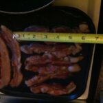 Flipped bacon cooking with tape measure