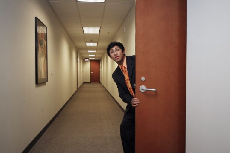 man sneaking off to another room