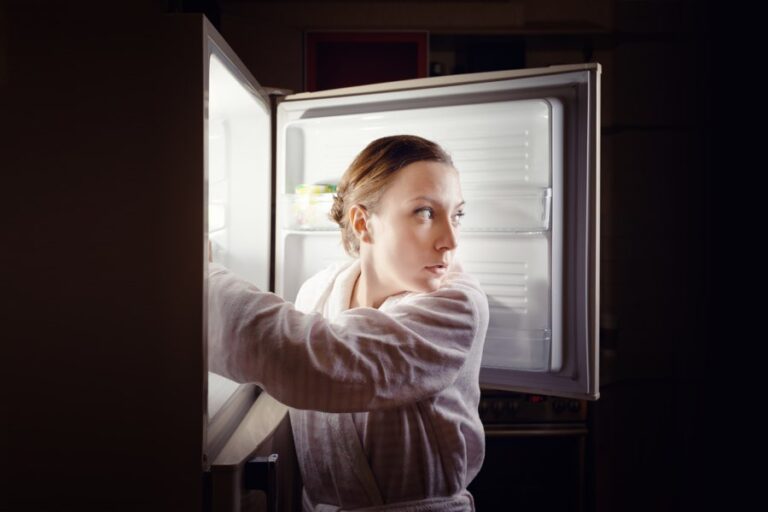 woman raiding fridge at night