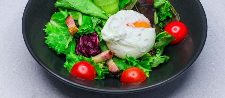Example of bacon in a diabetic meal. Salad with bacon chunks and egg.